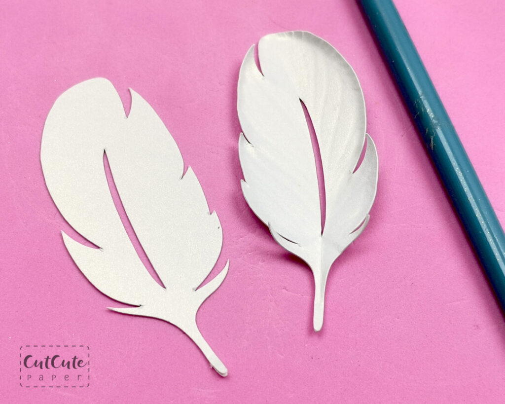 Sculpting the paper feather to give it some dimension and add detail