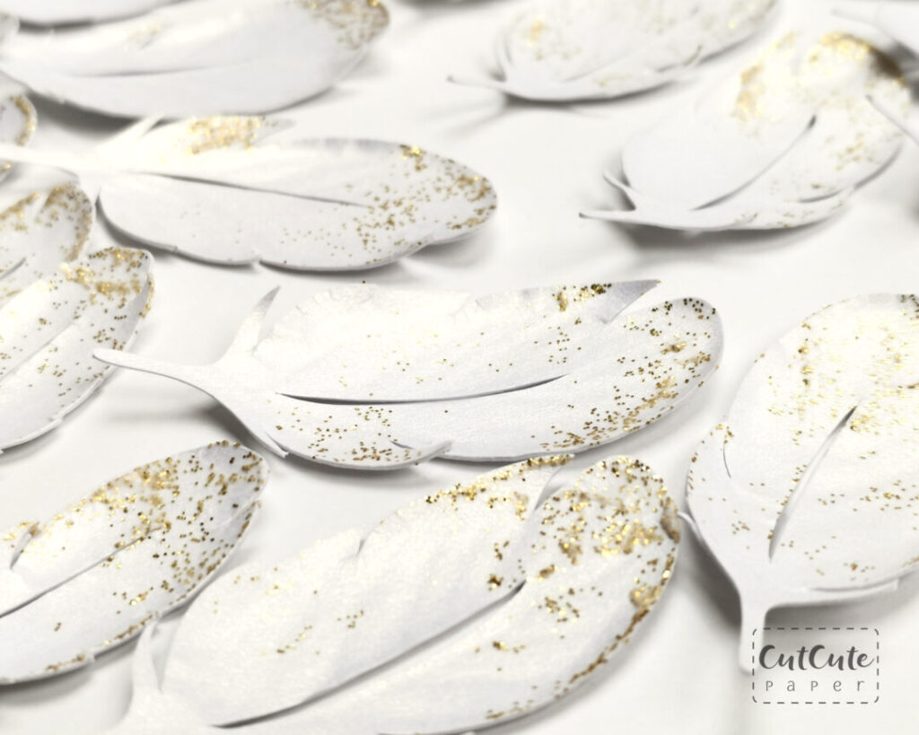 Drying sculpted cardstock feathers with applied glitter gel 